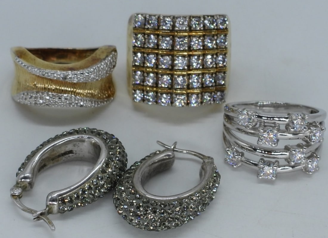 Sterling & Gold Tone Moissanite Rings & More: One sterling ring with moissanite gemstones and one diamond (tested), size 7. Two gold tone sterling rings with simulated diamonds, sizes 7 & 9. Sterling pierced hoop earrings, hang 1" long. 