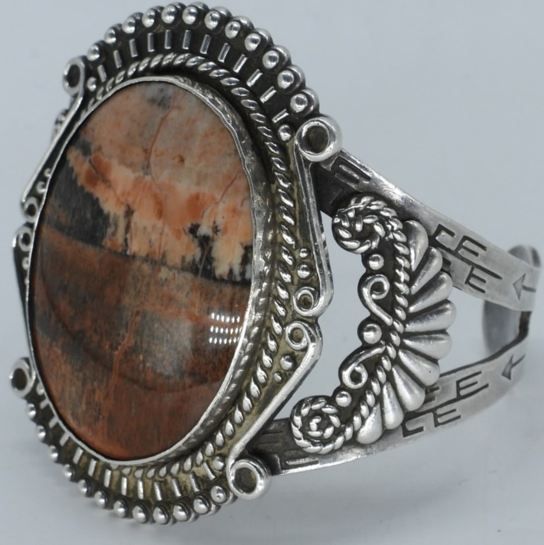 Navajo Style Sterling Petrified Wood Bracelet: Navajo style, unmarked (sterling tested) cuff bracelet with a large petrified wood gemstone. 7" inside, stone measures 1.5" x 1". (35 dwt)
