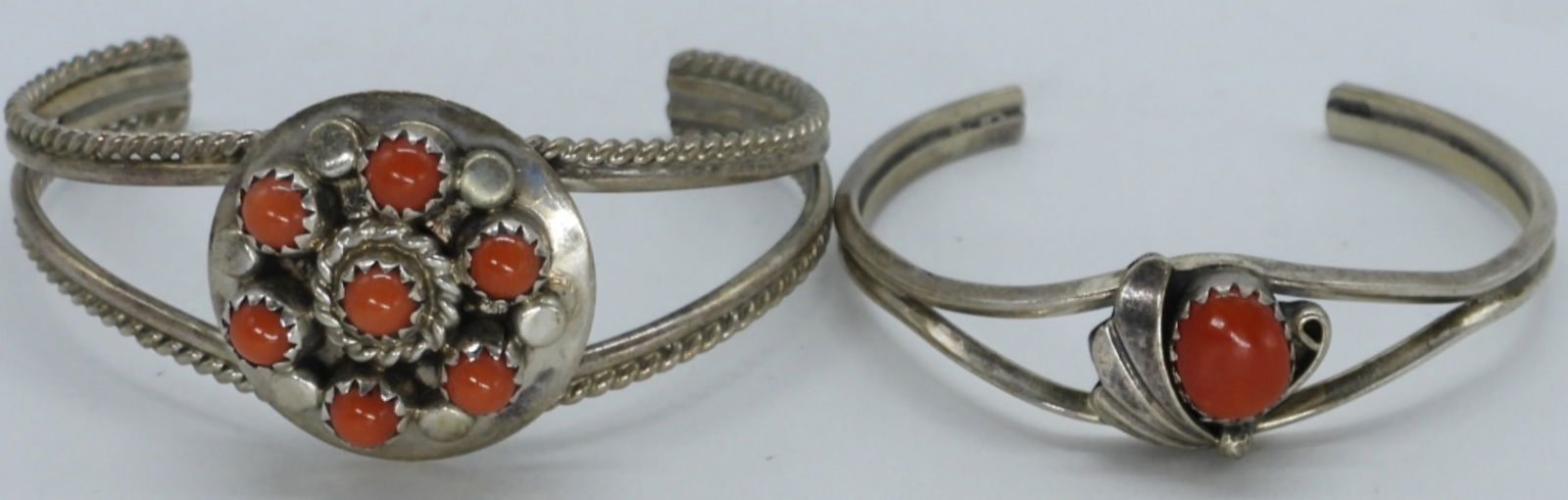 2 Petite Sterling Red Coral Cuff Bracelets: Two sterling petite cuff bracelets with red coral gemstones. 4" and 5" inside. (11 dwt)