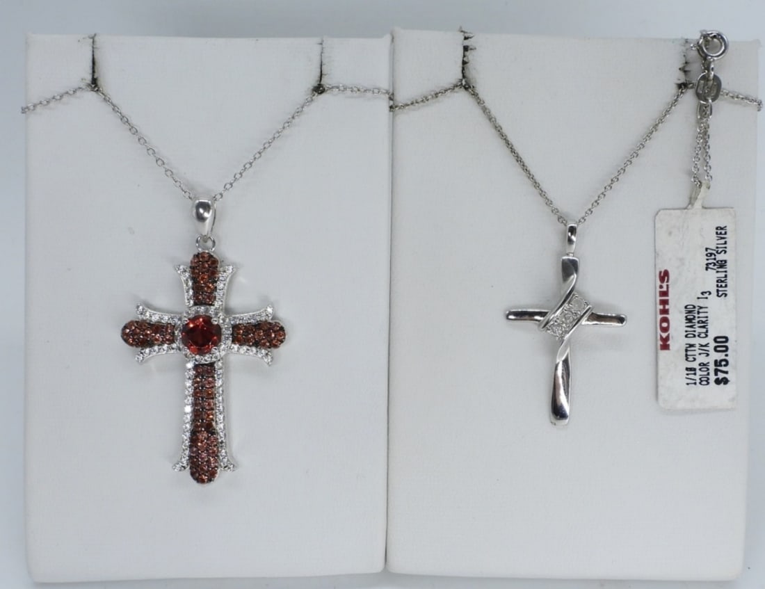 Sterling Cross Necklaces - Diamond & Garnet: Two sterling cross necklaces. Diamond pendant necklace has a Kohls tag still attached. Both chains are 18" long. (6 dwt)