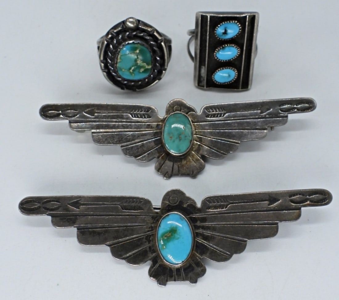 Thunderbird 925 Pins & Turquoise Rings: Two sterling thunderbird brooches with turquoise gemstones, 2.5" wide. Two sterling turquoise rings, size 6 & 7. (13.8 dwt)