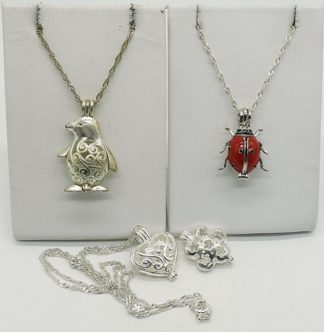 4 Sterling Scent Pendants & Chains: Four sterling pendants that open for scent balls. Three sterling chains, 18" & 20". (14.4 dwt)