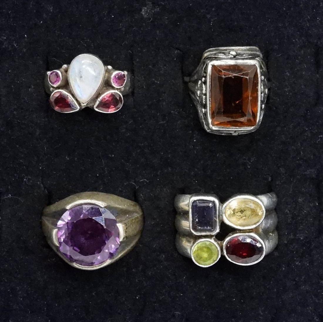 4 Sterling Amethyst, Citrine & Moonstone Rings: Four sterling gemstone rings. Amethyst, Citrine, Moonstone, Garnet. Sizes 3, 7, 8, 9. (20 dwt)