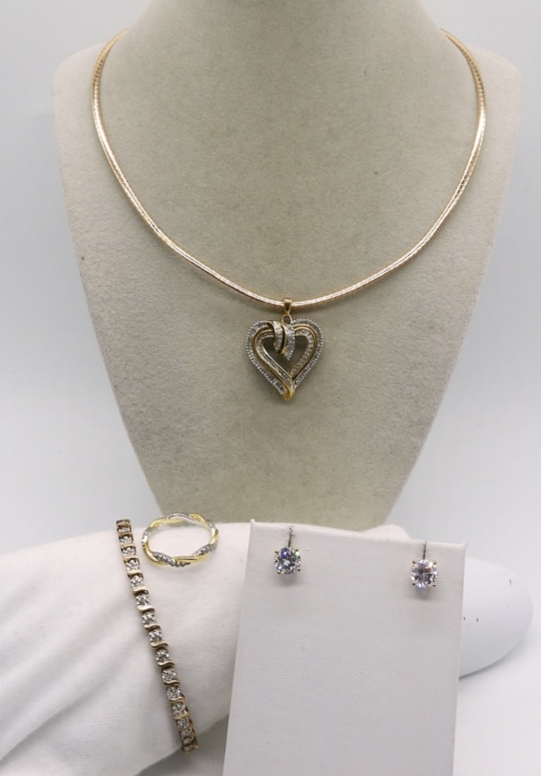 Gold Tone Sterling Diamond Necklace & More: Gold tone sterling diamond heart shaped pendant (stones testing as diamond and moissanite) on a 17" chain. Bracelet is 7.5" long. Ring size 8. (18.2 dwt)