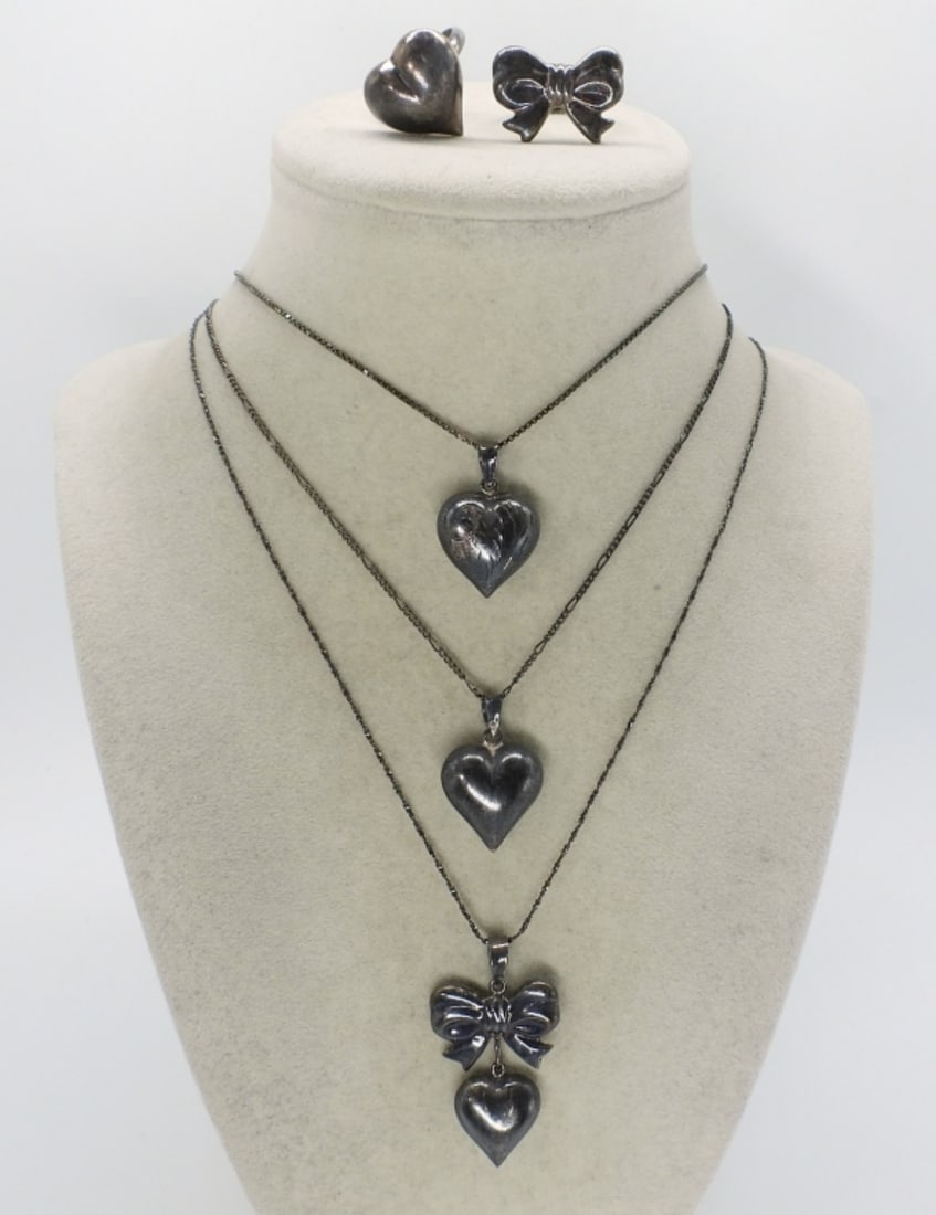 Vintage Sterling Hearts & Bows Jewelry: Vintage sterling heart necklaces and rings. Rings are size 7. Necklace chains are 20, 24 & 28 inches long. (15.1 dwt)