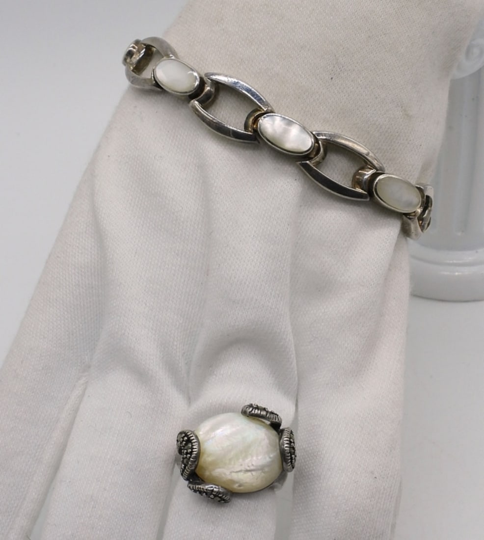 Mother of Pearl Sterling Set: Sterling mother of pearl bracelet, 7.5" long. Large mother of pearl gemstone ring with marcasite, size 6. (19.1 dwt)