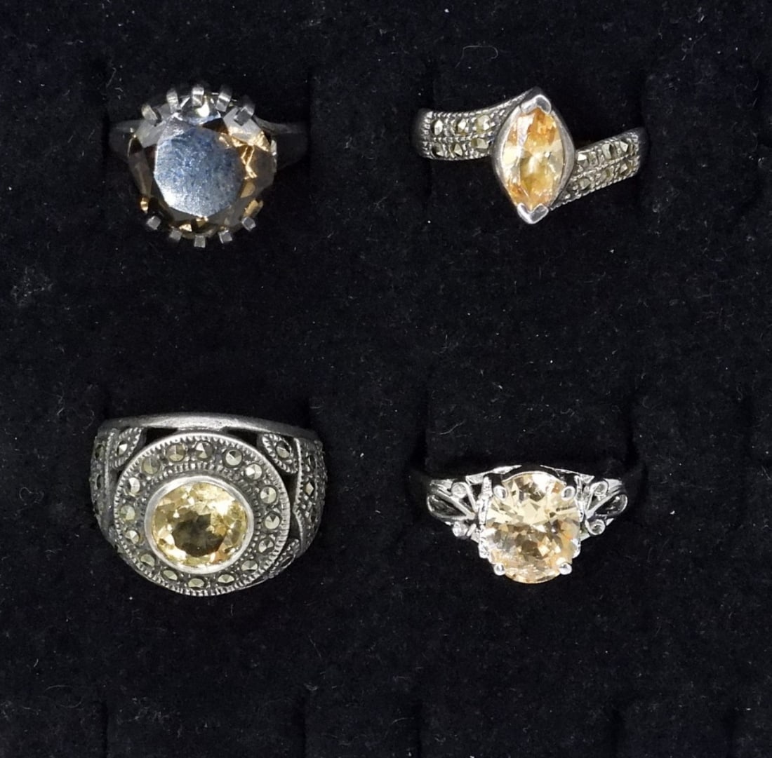 4 Sterling Champagne Colored Rings: Four sterling rings. Three have a pretty champagne color gemstone ( unidentified ), and one has a smokey quartz gemstone. Rings are size 6-10. (11.4 dwt)