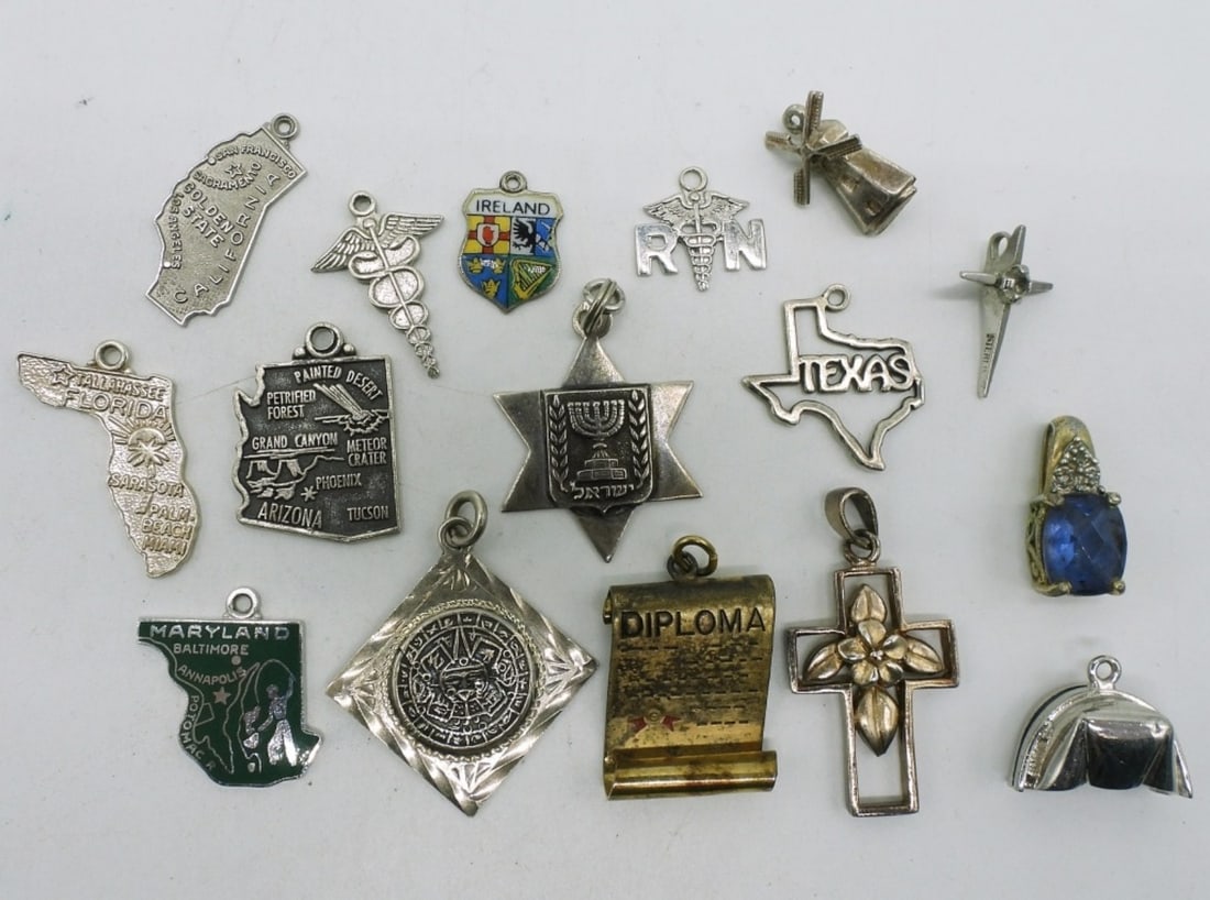 16 Vintage Sterling Charms & Pendants: Sixteen sterling charms and pendants. (18.3 dwt) (6x4x2)