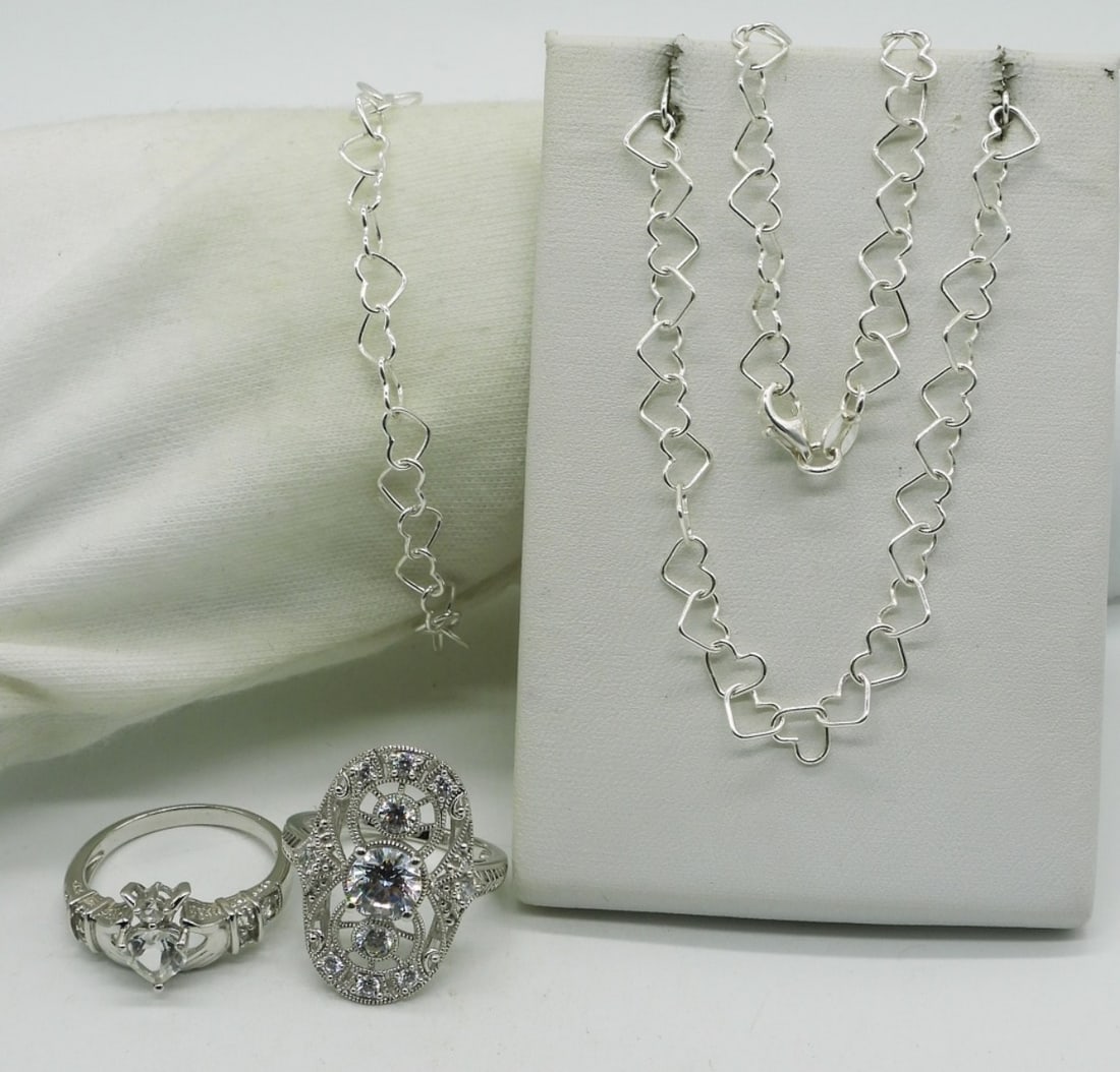 Matching 925 Heart Link Necklace Bracelet: Matching sterling heart link necklace and bracelet, 7" & 17". Two sterling simulated diamond rings, size 9. (11 dwt)