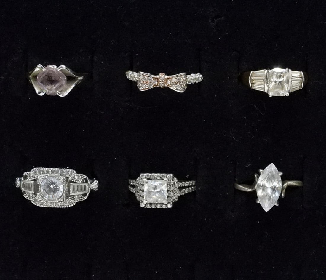 6 Sterling Sparkling Fashion Rings: Six sterling rings with simulated diamond gemstones. Sizes 5-7. (11 dwt)