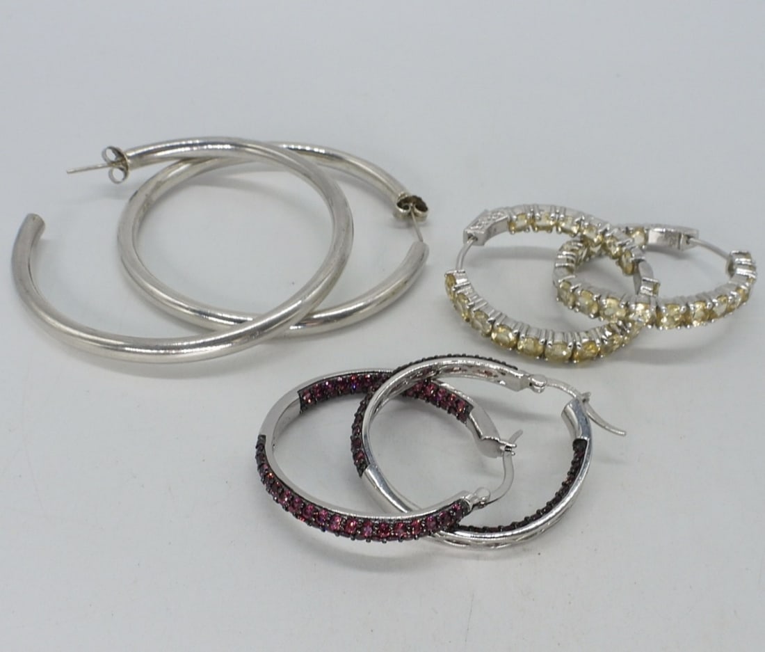 3 Pair of Pierced Sterling Hoop Earrings: Three pair of pierced sterling hoop earrings. Rhodolite Garnet & a Yellow Gemstone (both likely simulated). 1", 1.5" & 2". (16 dwt)