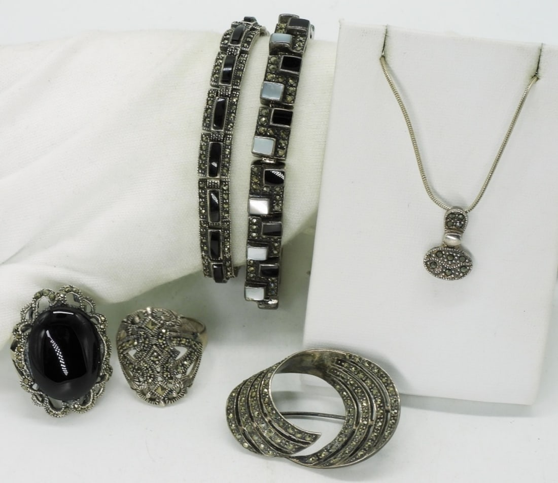 Marcasite, Onyx & Mother of Pearl 925 Set: Sterling marcasite, black onyx & mother of pearl pieces. Bracelets are 7" long. Necklace is 16" long. Two sterling rings, sizes 9 & 11. Brooch is 2" x 1". (48 dwt) (6x4x2)