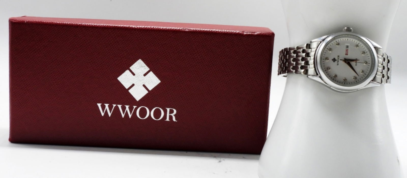 WWOOR Quartz Silver-Tone Watch: Date and Day dial with either English or Japanese days of the week to choose from. Quartz movement. Comes with its original box. Watches are not verified, authenticated, or tested in running