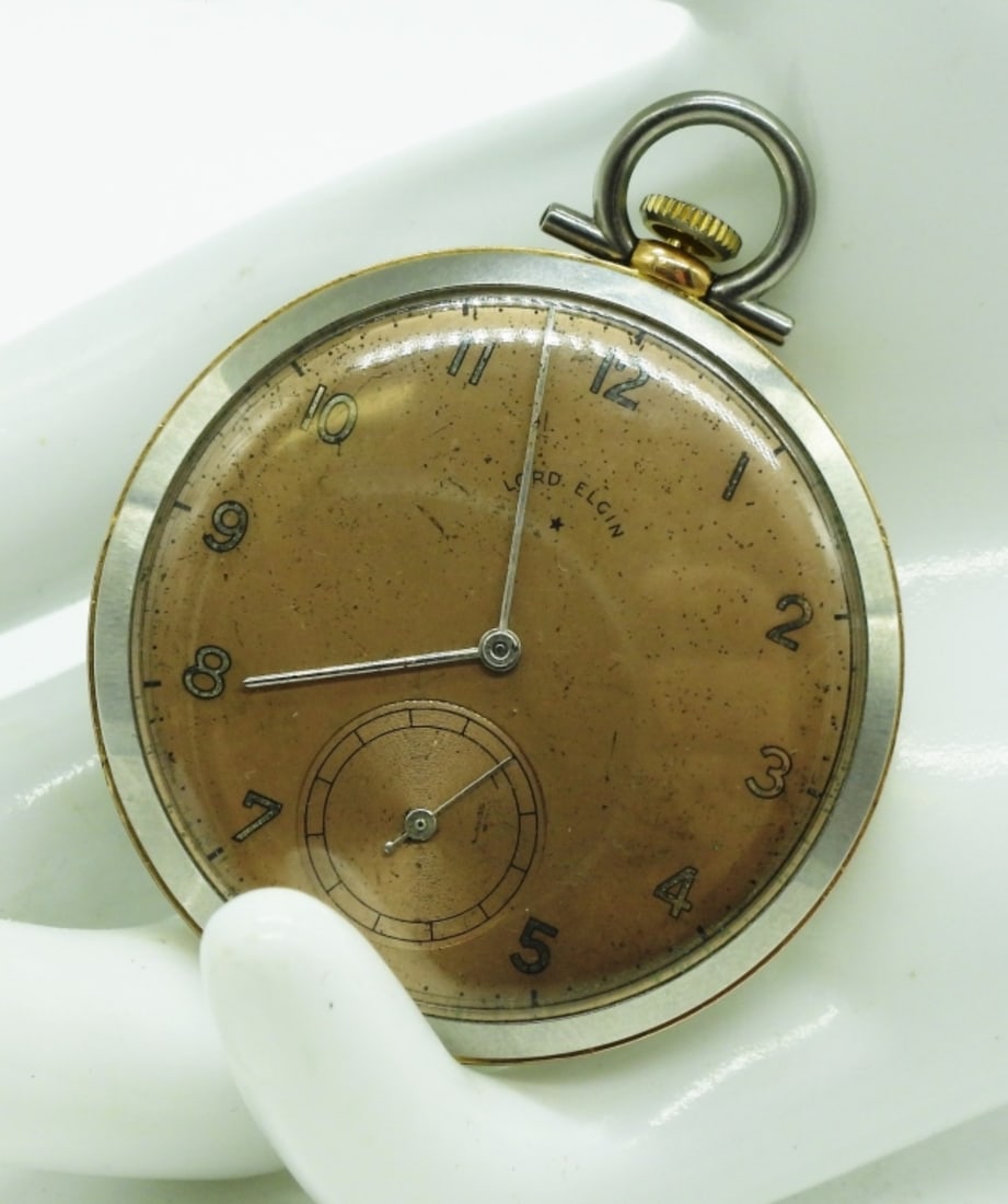Lord Elgin Pocket Watch: Featuring a champagne-colored dial with Arabic numerals and a sub-dial with a stem-winding mechanism. Watches are not verified, authenticated, or tested in running condition unless specified.