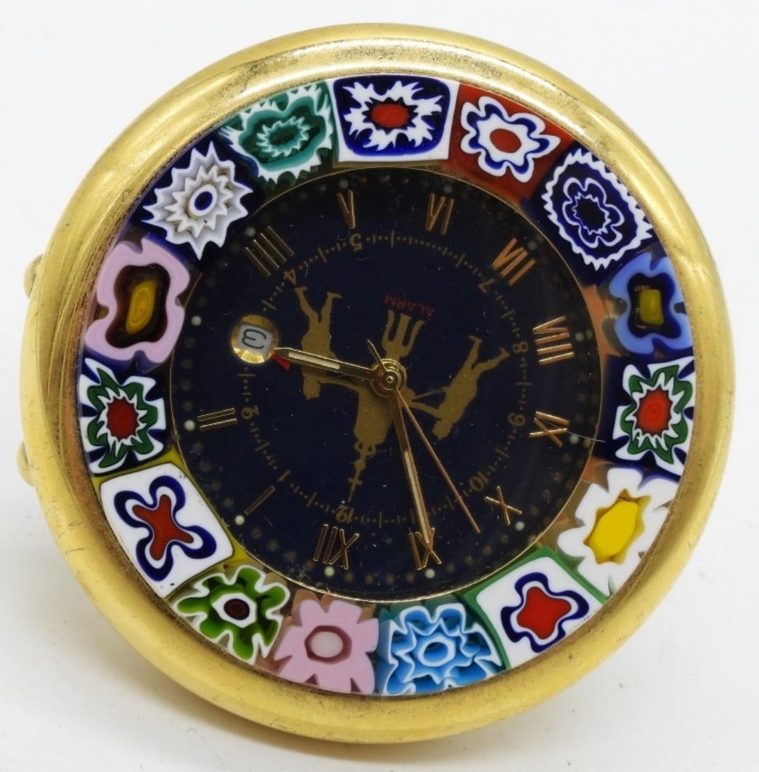 Venetian Murano Desk Alarm Clock: Depicts the St Mark's Clock Tower in Venice. Also has a colorful millefiori (thousand-flower) pattern around the bezel. The back does not stay on. Watches are not verified, authenticated, or