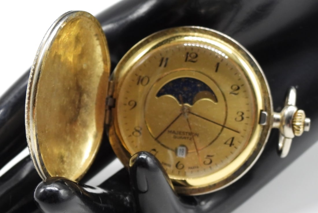 Majestron Moon Phase: Displays the date and features a decorative moon phase dial. Watches are not verified, authenticated, or tested in running condition unless specified.