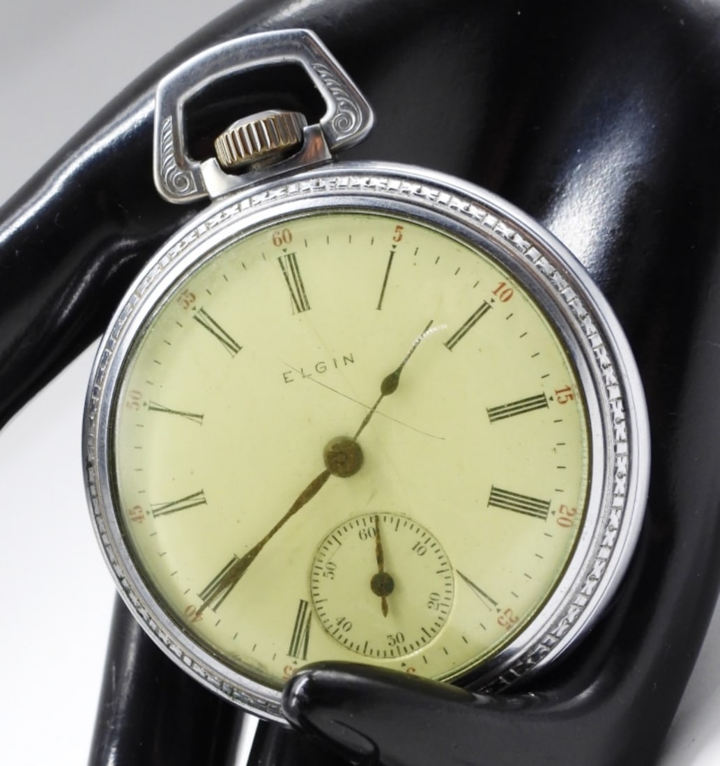 Elgin Open Face Pocket Watch: The watch features a cream-colored face and Roman numerals. Watches are not verified, authenticated, or tested in running condition unless specified.