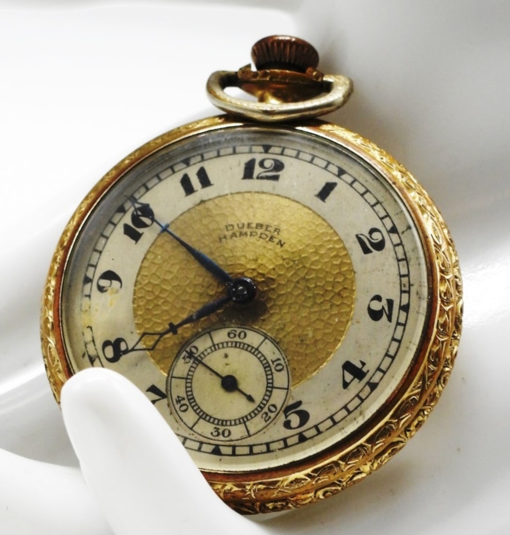 Dueber Hampden Pocket Watch: This watch features a silver and gold colored dial with Arabic numerals and a sub-dial. Watches are not verified, authenticated, or tested in running condition unless specified.