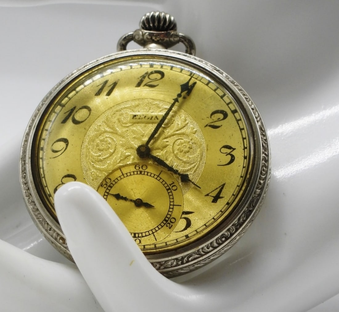 Elgin Pocket Watch: This watch's has a decorative floral design engraved on the dial center. Watches are not verified, authenticated, or tested in running condition unless specified.