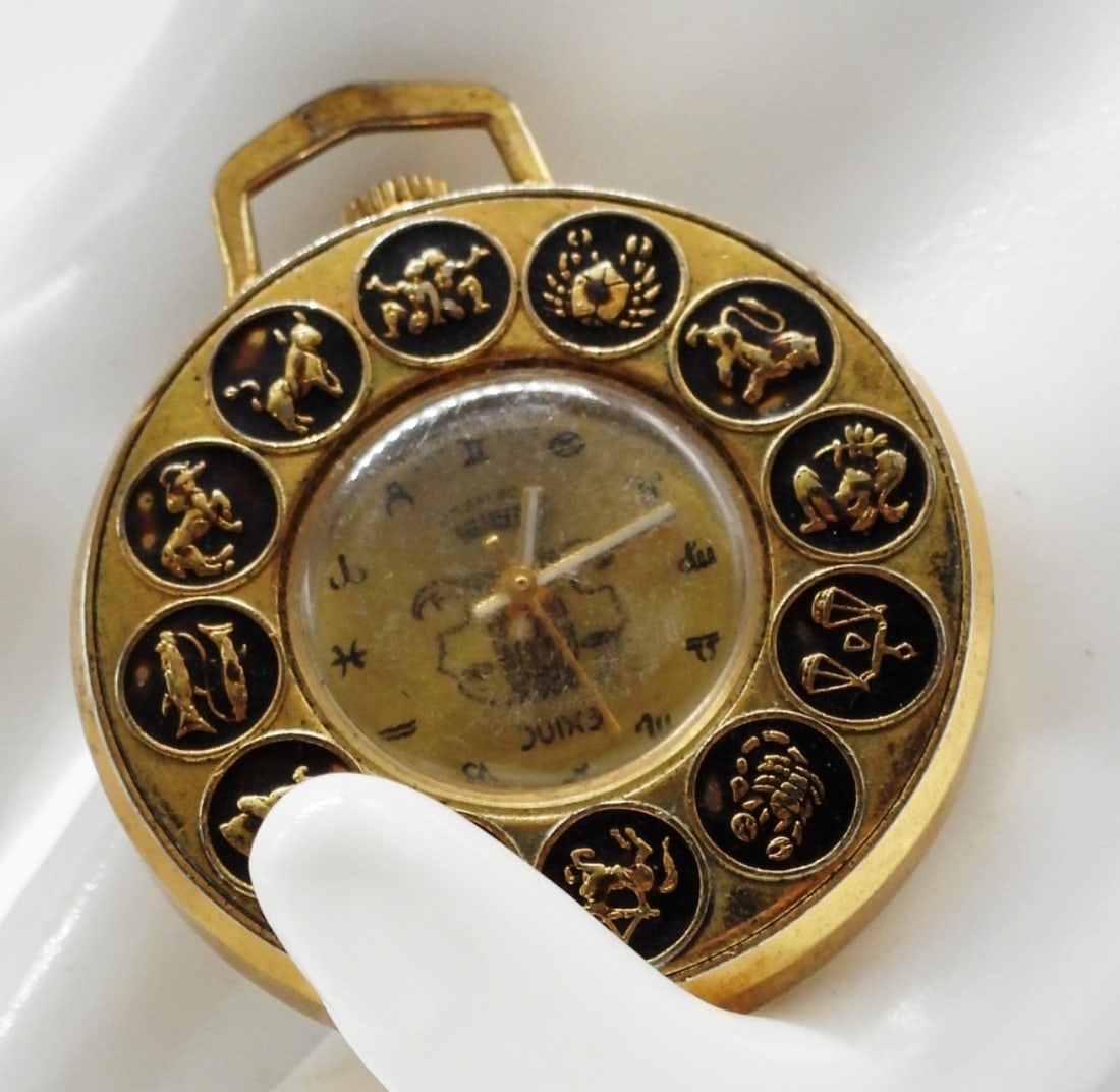 Exinc Zodiac Pendant Watch (Gemini): Working! The glass is scuffed. Watches are not verified, authenticated, or tested in running condition unless specified.