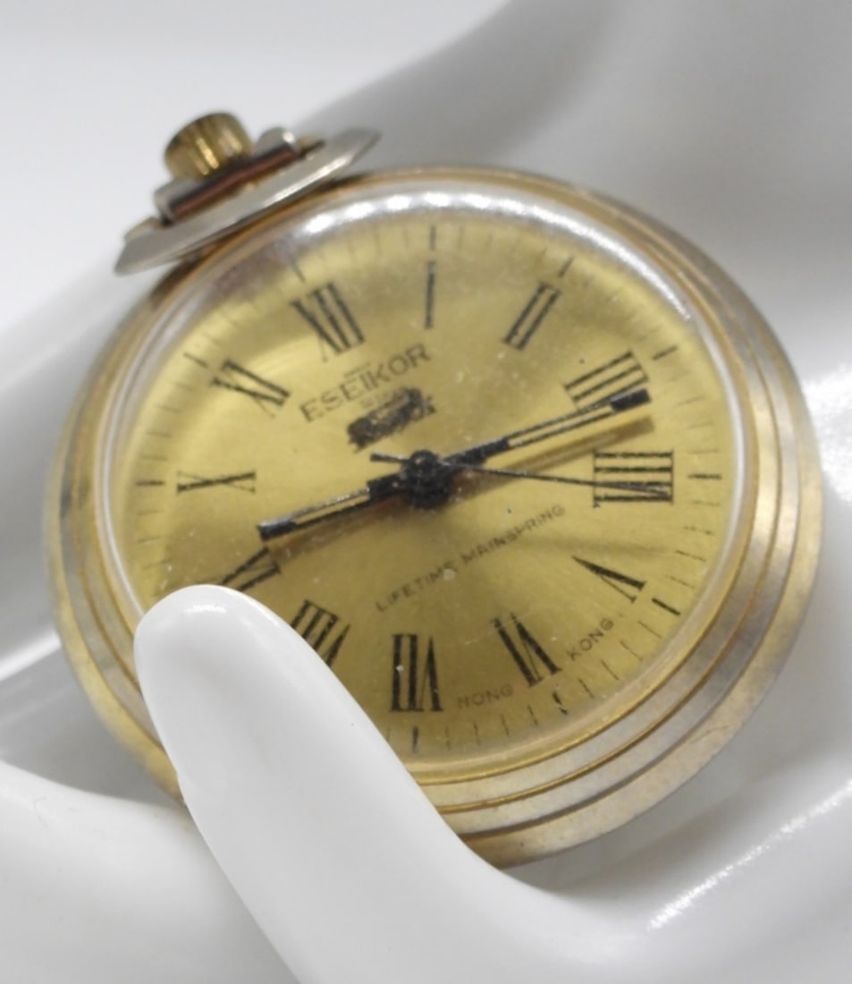 Eseikor Pocket Watch: Works! This watch features a gold-tone face with Roman numerals. Watches are not verified, authenticated, or tested in running condition unless specified.