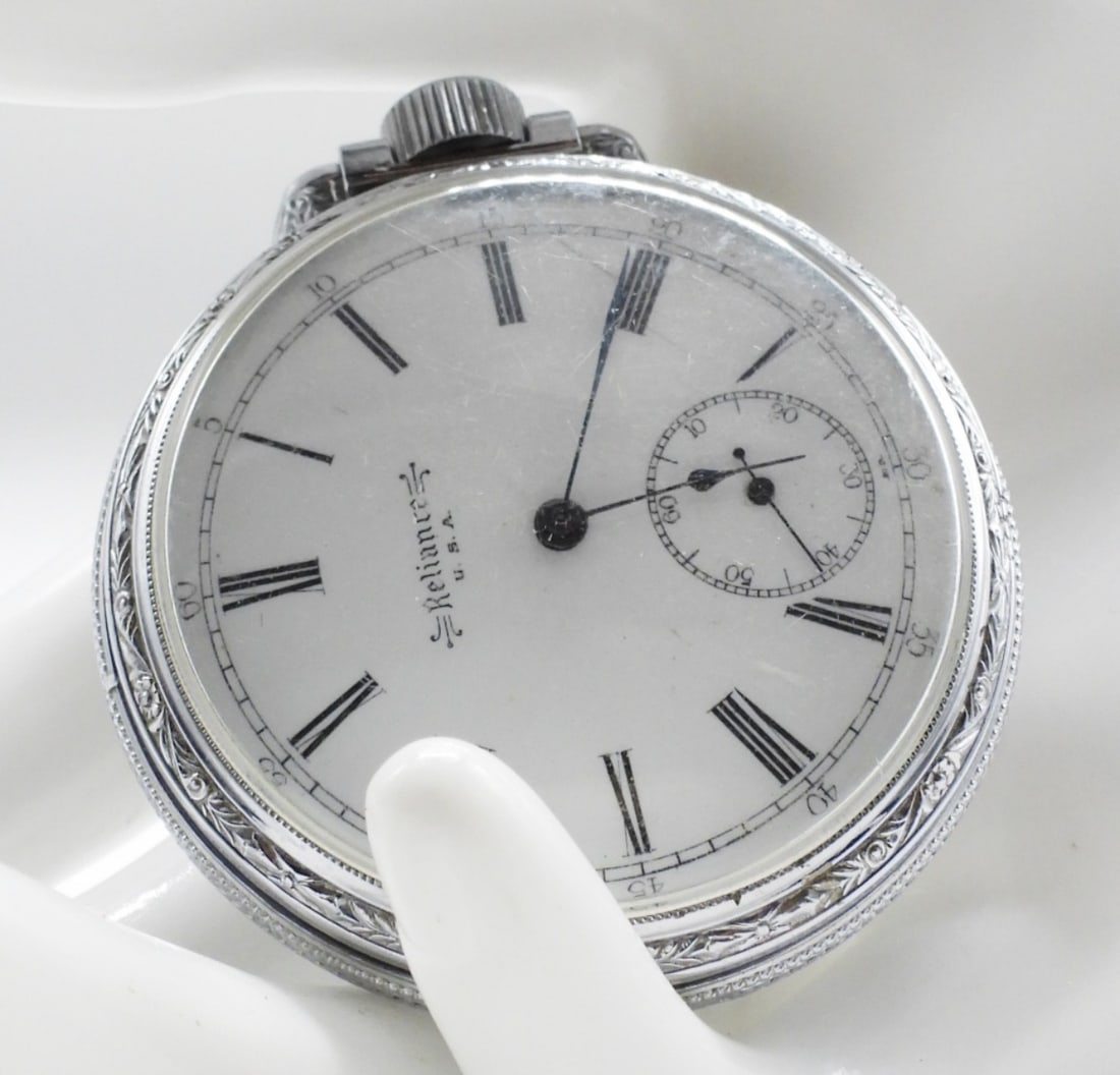 Reliance U.S.A Pocket Watch: This watch has a stem-winding mechanism and an engraved metal case. Watches are not verified, authenticated, or tested in running condition unless specified.