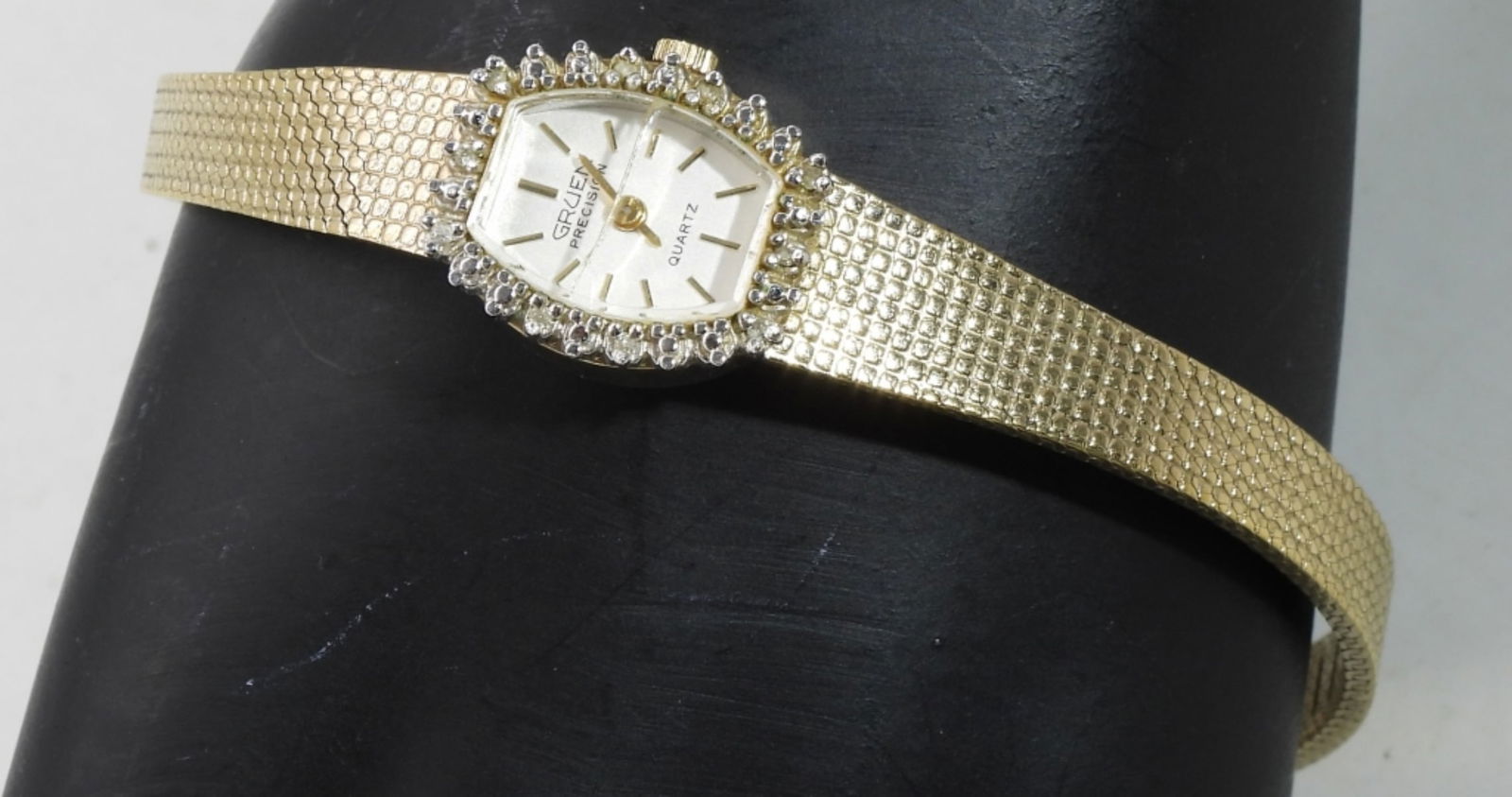 Gruen Ladies Gold & Rhinestone Watch: Has a cracked face Watches are not verified, authenticated, or tested in running condition unless specified.