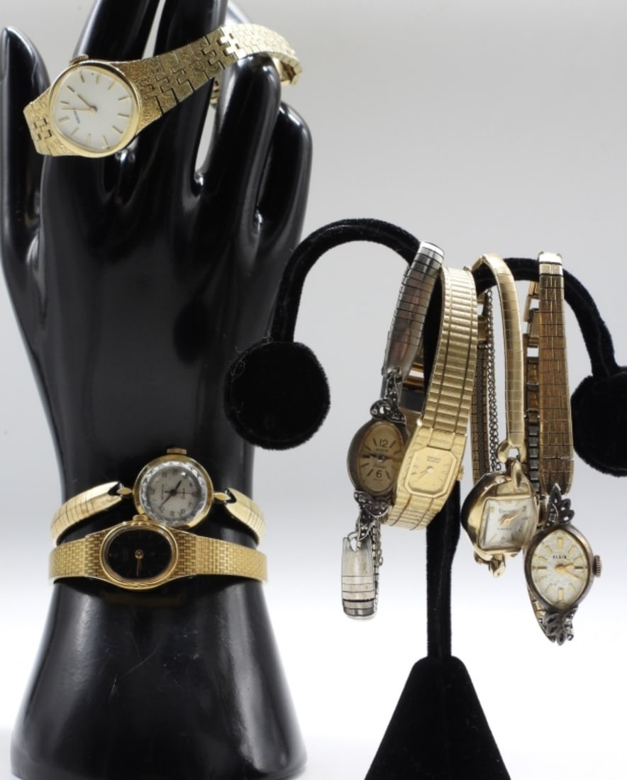 (7) Dainty Ladies Fashion Watches: All different styles, gold-tone. Clasp bands with a catch chain. Some brands: Austin, Wittnauer, Seiko. Watches are not verified, authenticated, or tested in running condition unless specified.