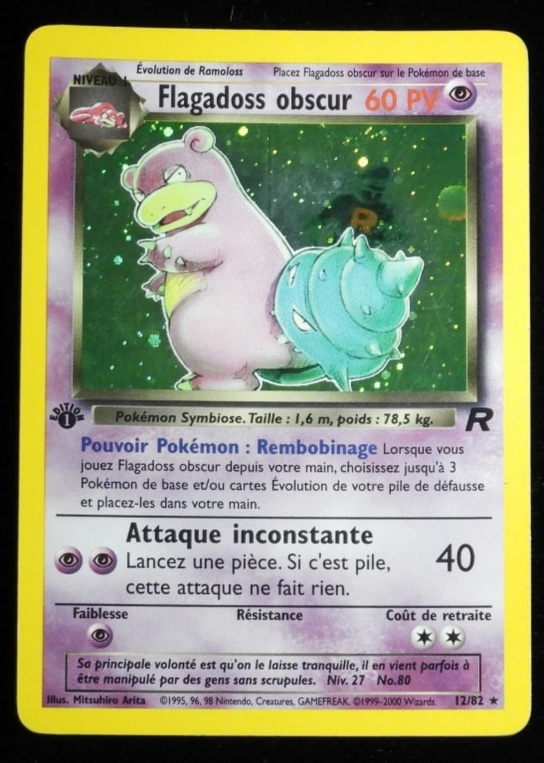 Dark Slowbro 1st Edition Holo 12/82 French: French version Flagadoss Obscur. 12/82 rare holo. First edition 60HP. In G/VG condition with a crease at the top of the card.
