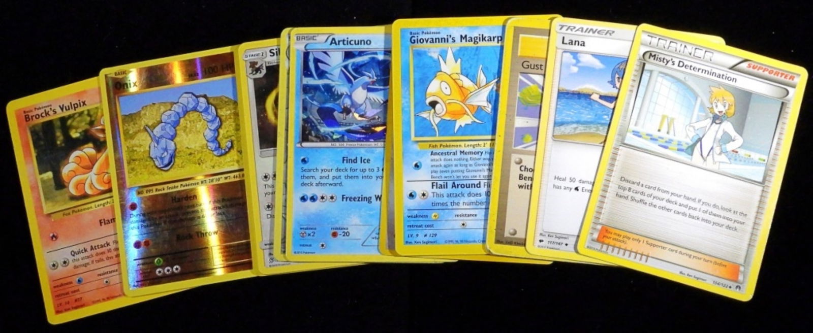 (15) Mixed Lot Of Pokemon Cards: Most of the cards are Holo Foil, as well as trainer cards