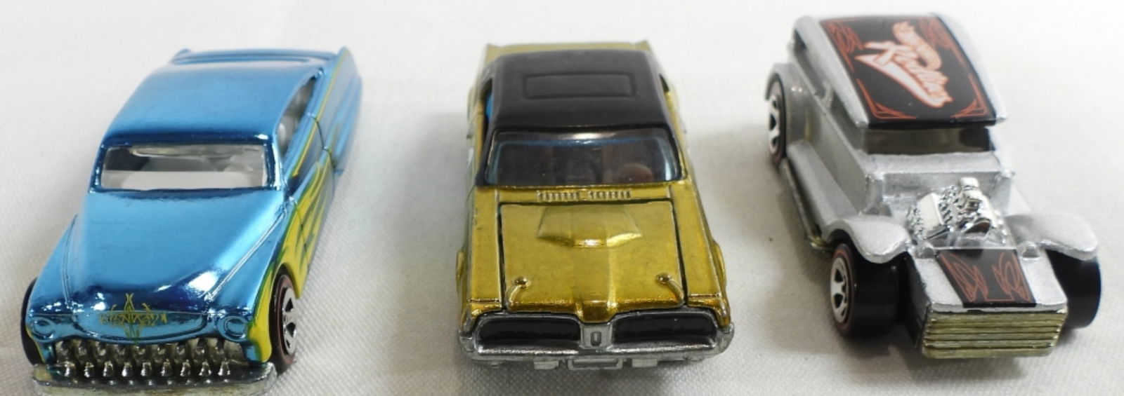 (3) Redline Hot Wheels Cars: Not in packages. 1. 2018 50th anniversary 1968 Mercury Cougar. Gold with a black top. 50 on the sides. Hood opens. Brown inside. 2. 1969 The Demon Redline 1/64. Silver with a black top and hood with r