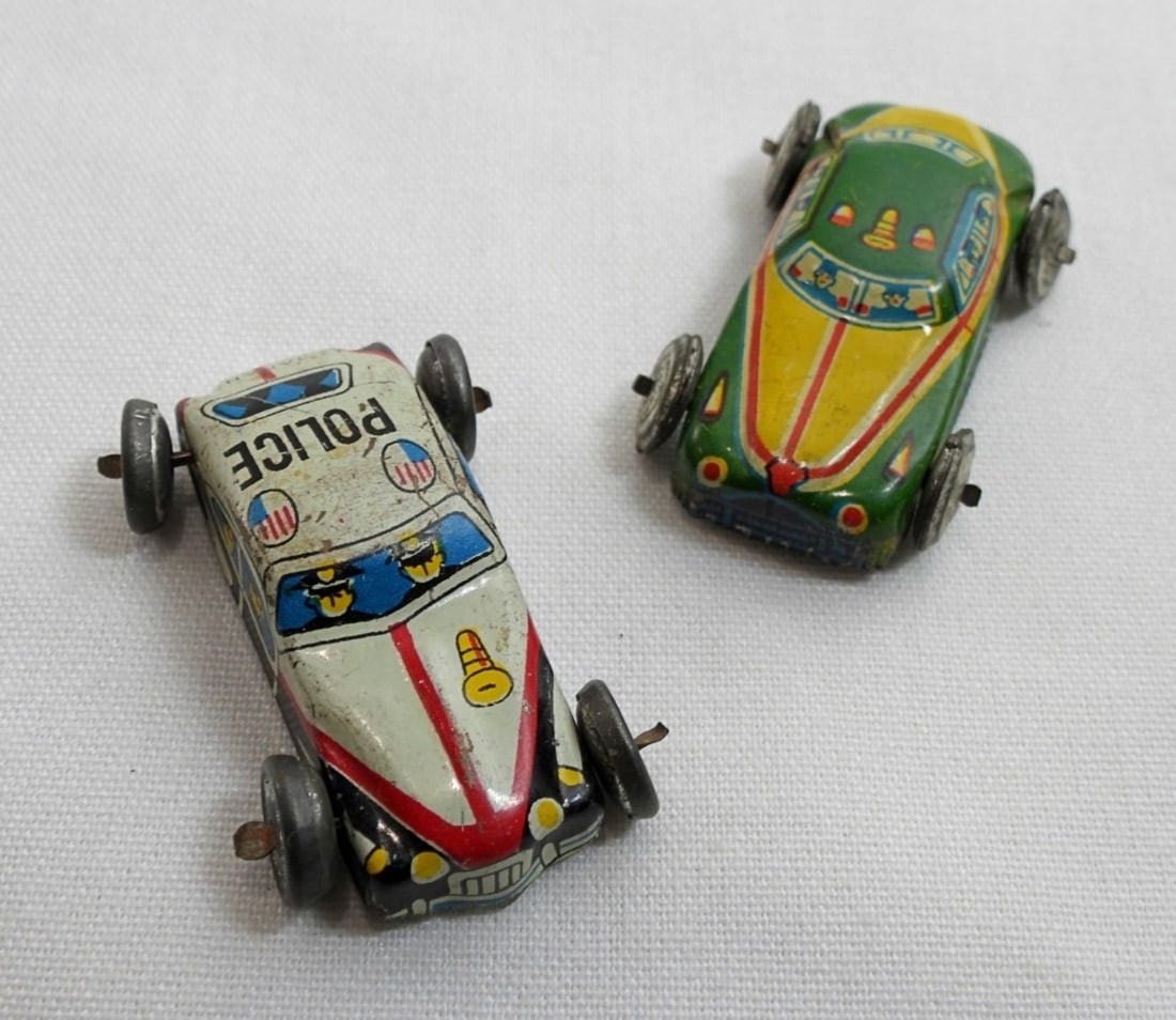 (2) Japan Tin Litho Mini Toy Cars: Both are about 1 inch long Police cars. In fair to good condition, pre owned.