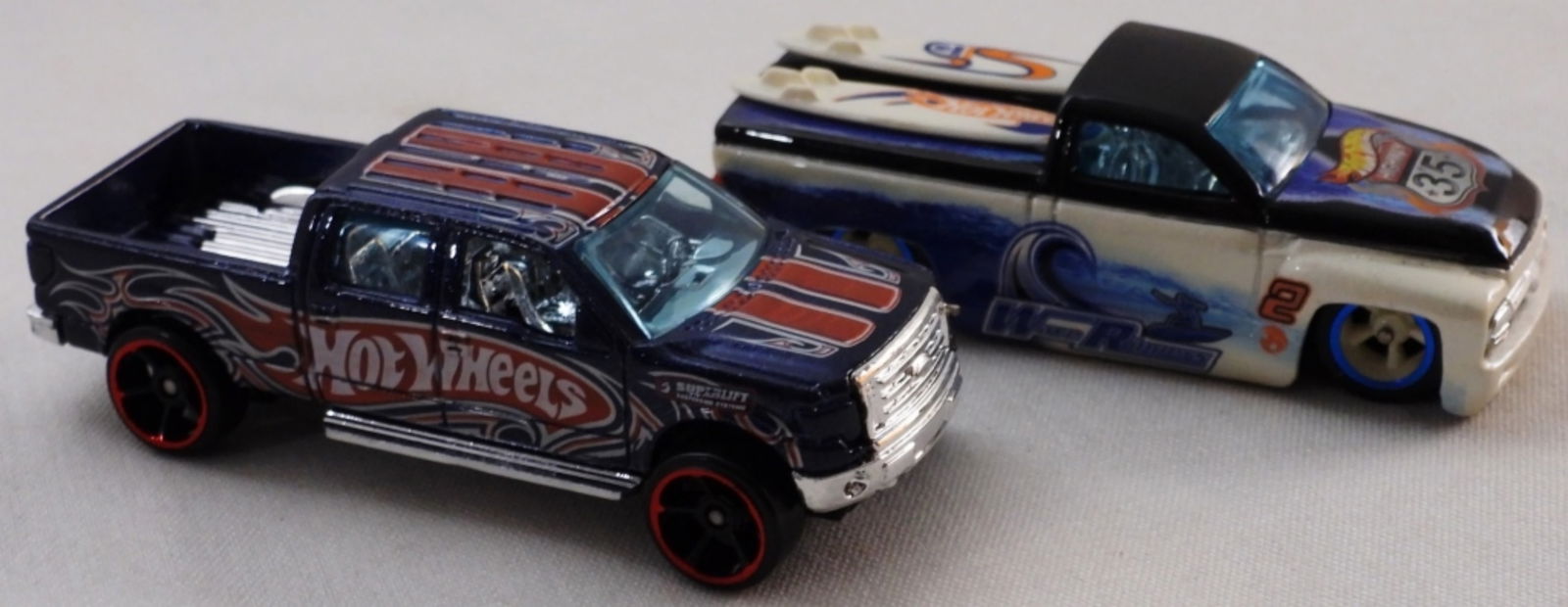 (2) Hot Wheels Trucks: 1) 2009 Ford F-150 Made in Malaysia. 2) Switchback. Made in 2002 in Thailand