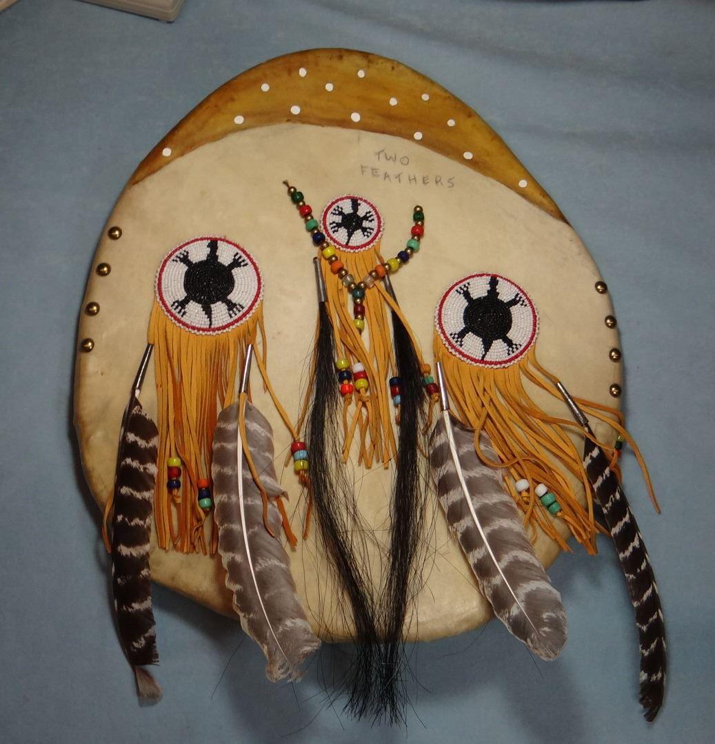 Blackfeet shield -two feathers, 17" w LN 1: Blackfeet shield -two feathers, 17" w