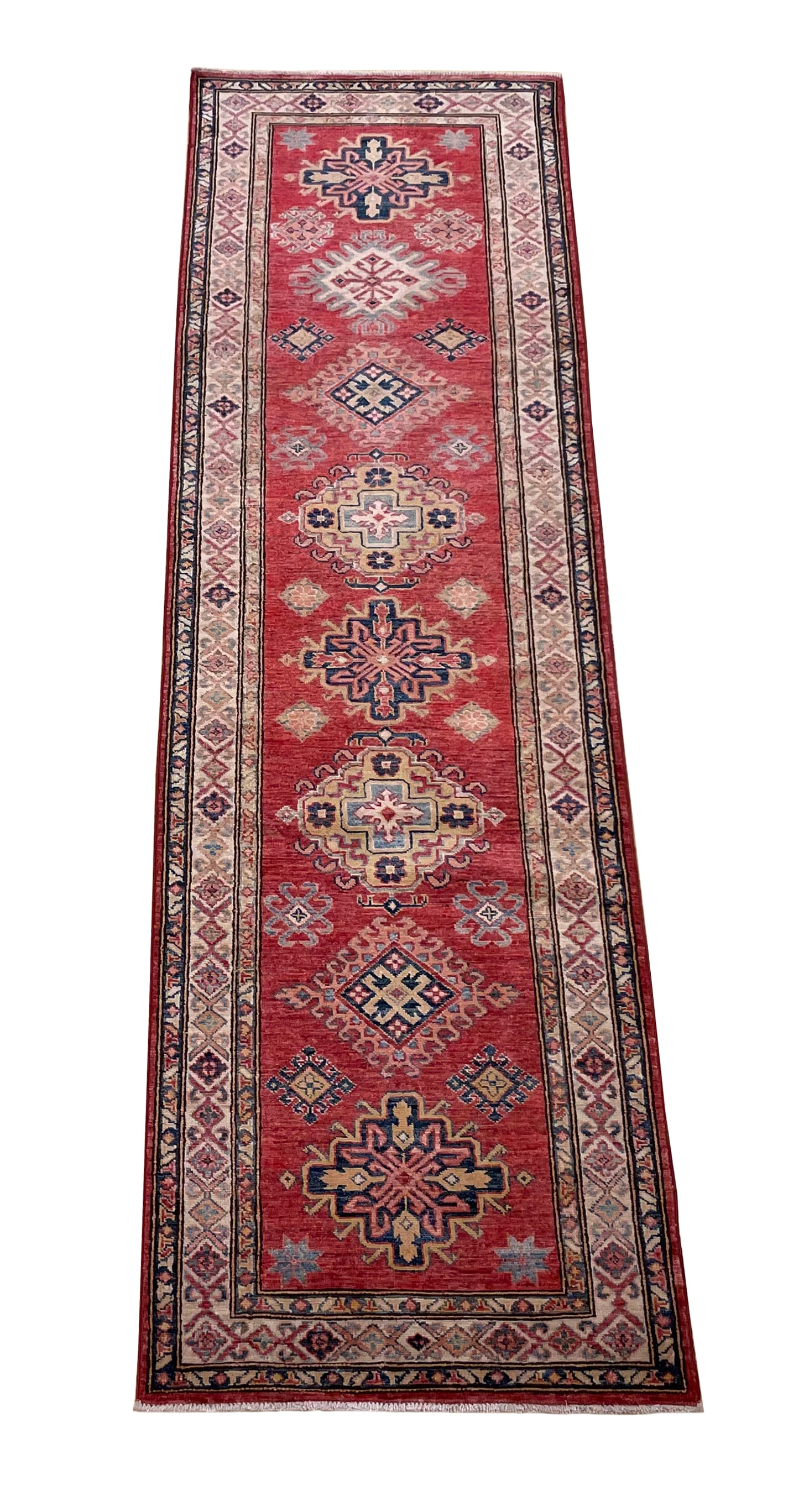 Persian Kazak D179 2'8" x 9'2" hand knotted: No Reserve Kazak D179This runner displays a traditional Persian-inspired geometric design featuring a series of diamond and medallion motifs arranged symmetrically along its rich red field. The motifs