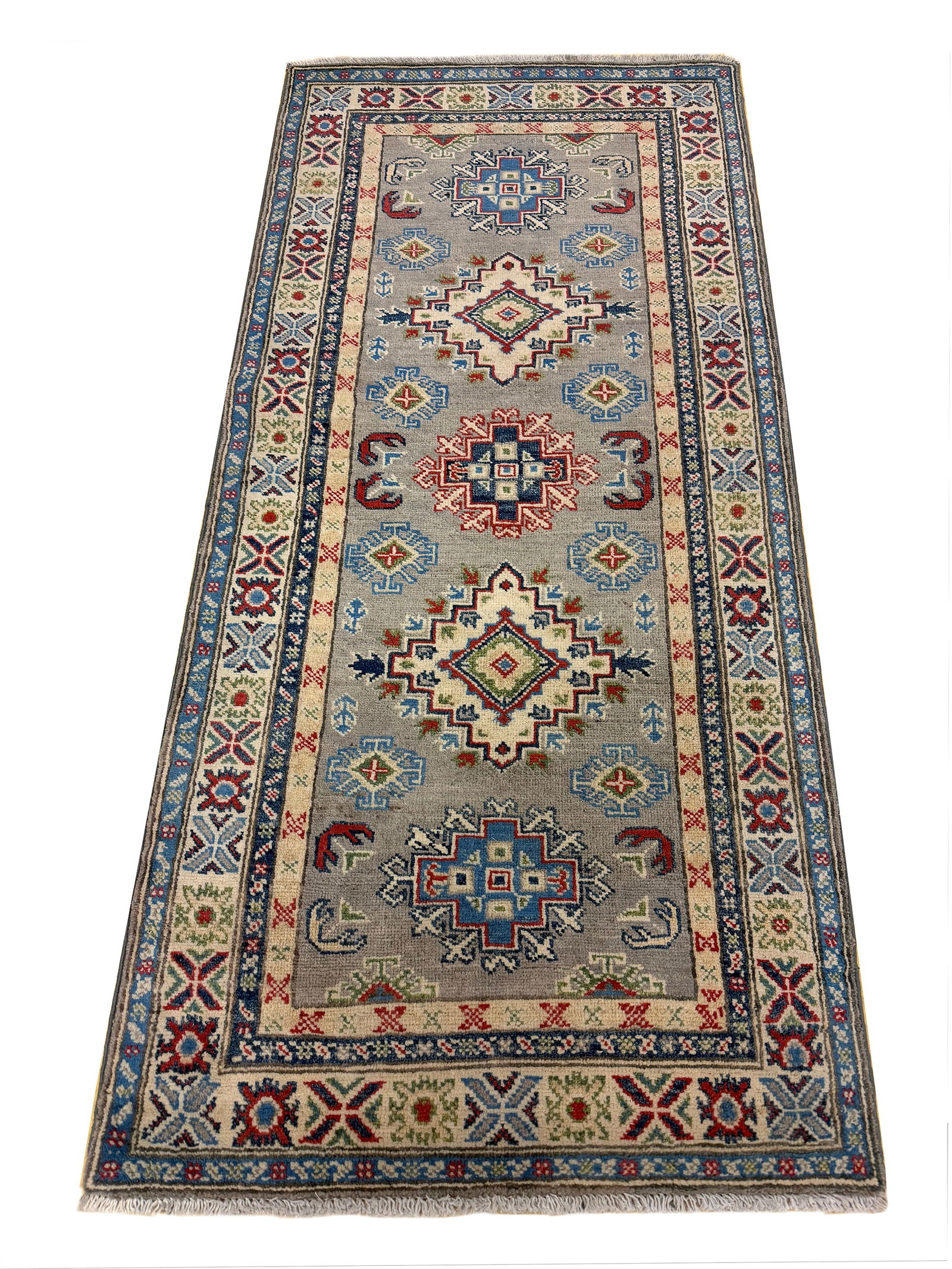 Persian Kazak D873 2'9" x 6'1" hand knotted: No Reserve Kazak D873 2'9"x6'1" This runner displays a traditional Persian-inspired geometric design featuring a series of diamond and medallion motifs arranged symmetrically along its rich red field.
