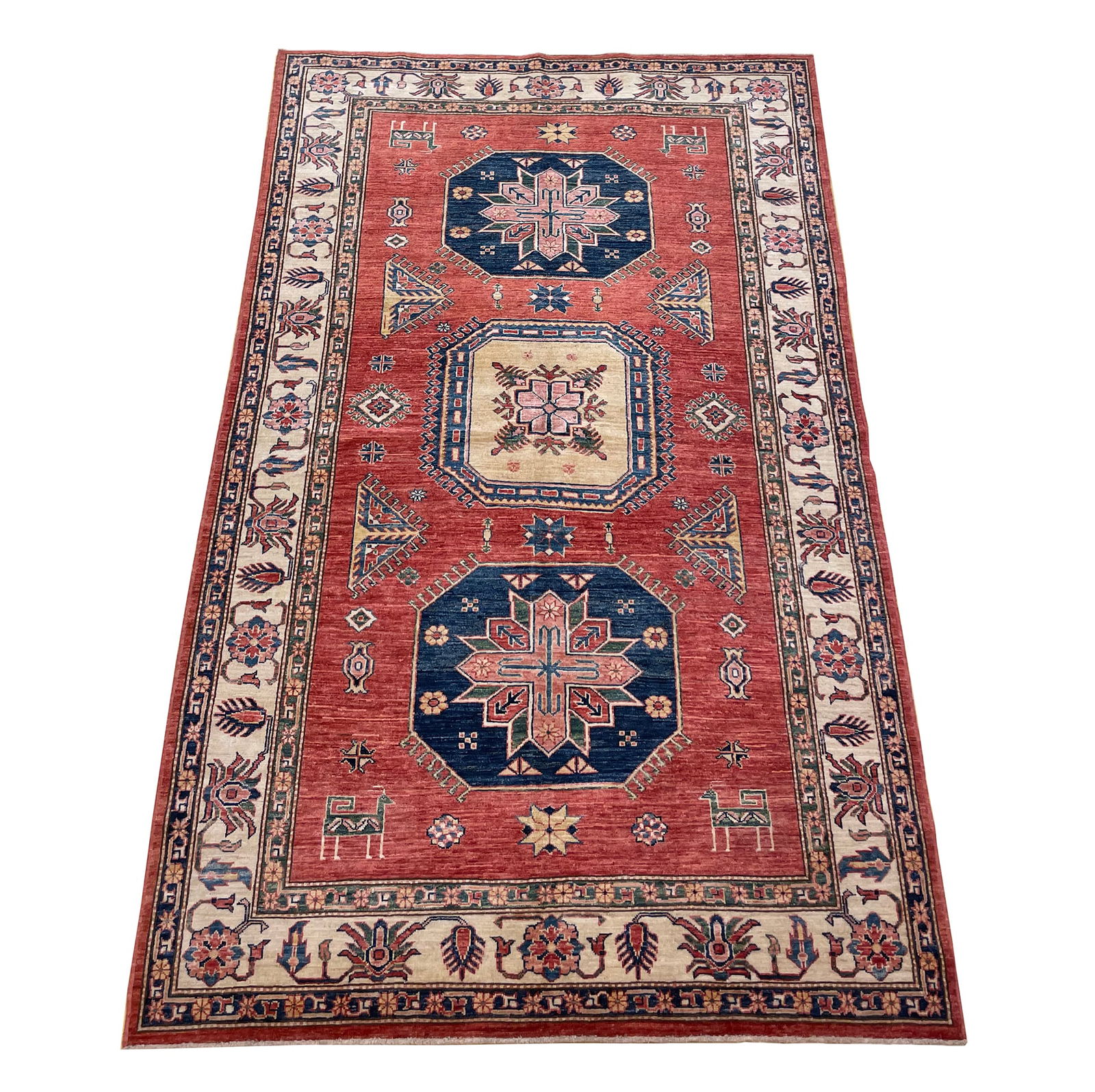Persian Kazak D173 size 5'4" x 8'3" hand knotted: No Reserve Kazak D173, size 5'4"x8'3"This rug features a classic Kazak design, admired for its bold geometric motifs, rich coloring, and strong tribal character. The vibrant terracotta-red field provi