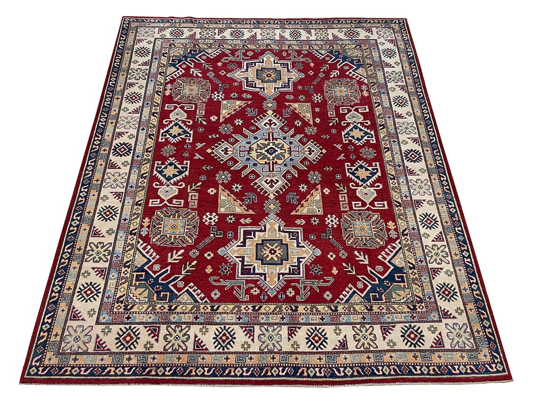 Persian Kazak D161 Size 8'2" x 9'10" hand knotted: No Reserve Kazak D161, 8'2" x 9'10". This rug beautifully embodies the spirit of traditional Kazak craftsmanship, known for its bold geometric motifs, vibrant colors, and tribal elegance. Made with na