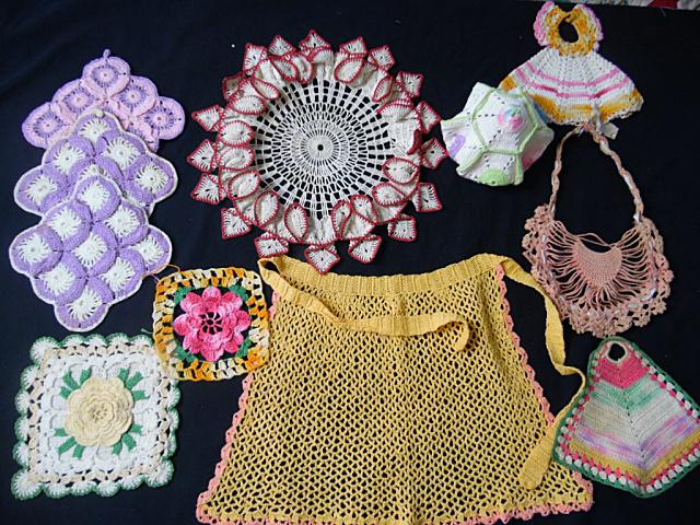 Vintage Crocheted Linen Grouping: Vintage Crocheted Linen Grouping including a childs apron, several small pot holders or trivets, a dimensional doily, and a decorative ball.