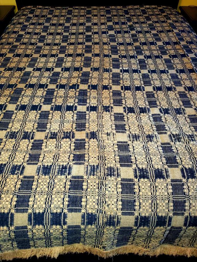 Antique 19th Century Woven Jacquard Coverlet: Antique 19th Century Woven Jacquard Coverlet in Blue and off White measuring 72 inches by 80 inches with 1-2 inches of fringe on 3 sides. Hand sewn seam down the center. In good condition, one area wi