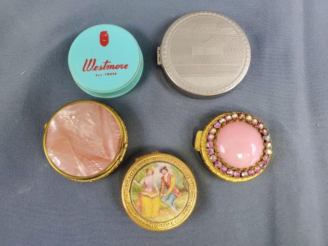 Group of 5 Small Vintage Compacts: Group of 5 small vintage compacts, none larger than 2 inches in diameter. Includes a pink stone surrounded with rhinestone in gold tone, with sifter, marked Austria. Pink stone on both sides in gold t