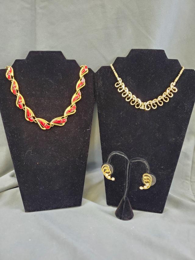 Two Vintage Necklaces - Trafari and more: Vintage gold tone and red enamel Trifari necklace, and a gold toned with rhinestone necklace and matching clip on earrings, unmarked. Both in very good condition. All stones present on rhinestone set.