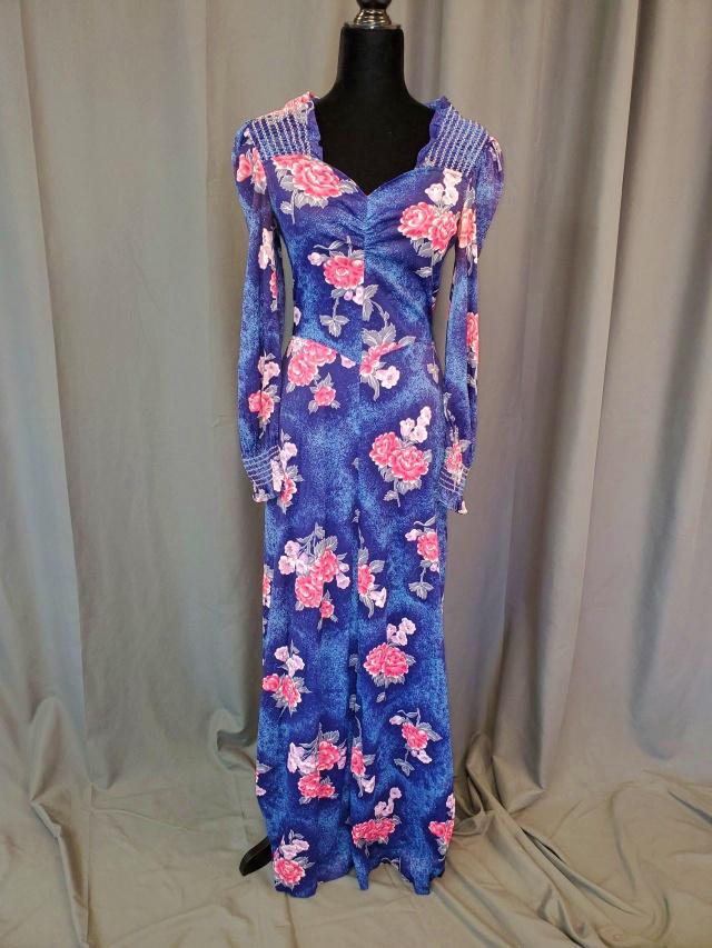 Vintage Floral Maxi Dress: Vintage Ladies Floral on Blue Maxi Dress by Mindy Malone, late 1970s - early 1980s, with smocked shoulders and cuffs and sweet heart neckline, fit and flare skirt, ties in the back, synthetic material