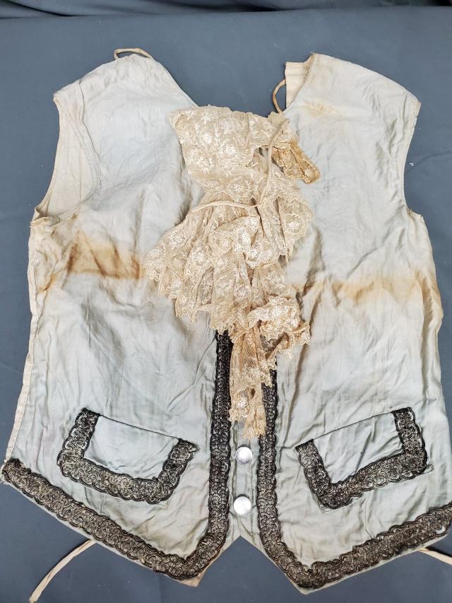 Mens Vintage Re Enactment Costume Vest: At a glance, this piece appears to be an 18th century man's vest, but the machine stitching dates it much more recent. Probably 20th century with a lace ruffle, small metal buttons, and metallic gimp 
