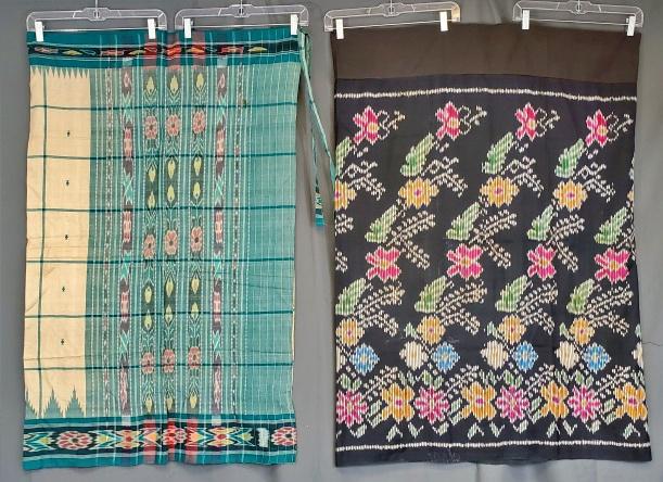 2 Vintage Asian Wrap Skirts: Two vintage Asian wrap skirts including a black silk with colorful flowers, measuring 44 x 66 inches, sewn together like a tube by machine, no ties, in good condition with some white spots. Green ikat