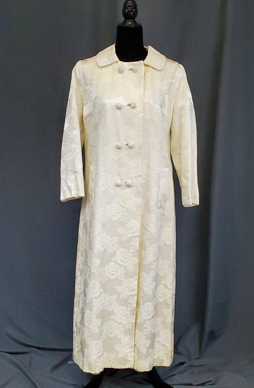 Vintage Ivory Damask Coat: Vintage Ivory Damask Coat or Duster with Rhinestone Buttons. Tag by Elsie Gallavans of Trenton, NJ. Pockets are faux. Measures laying flat Bust 20" and Length from back of collar to hem 50" . In verry
