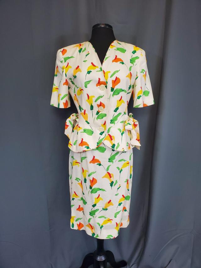 Vintage Valentino Crepe Suit: Vintage Valentino crepe suit, button down short-sleeved jacket and skirt in an ivory crepe with orange and yellow flowers with red centers and green leaves. Measurements laying flat: skirt waist is 14