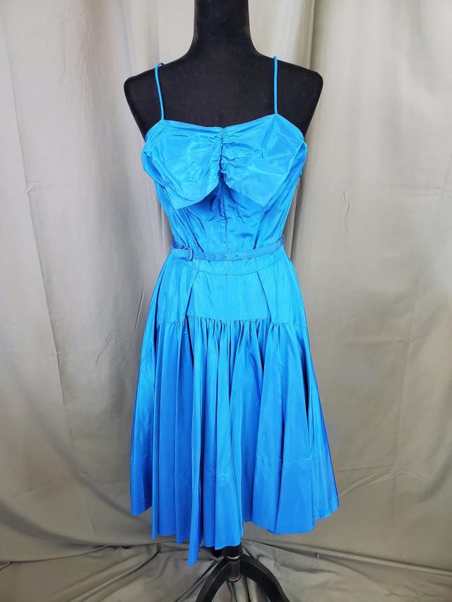 Vintage Blue Taffeta Party Dress: Vintage blue taffeta party dress with belt, A-line figure, pleated/tucked bow-shaped bodice, spaghetti straps, , back zipper, possibly homemade, no tags, measurements while laying flat: 16 inch bust,