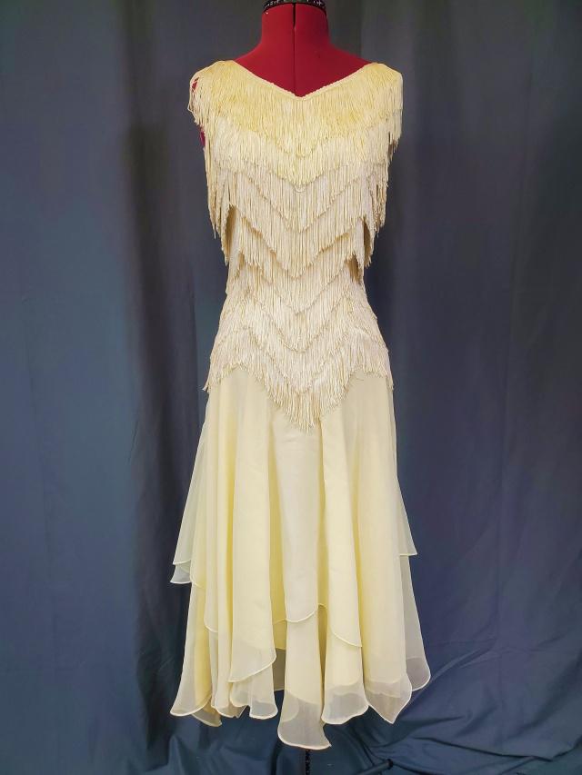 Vintage Fringe Dress by TD4 Electra: Vintage Dress by TD4 Electra in an ivory color, size 3/4. Several tiers of fringe cover the bodice, off the shoulder fringe element, and a pale yellow chiffon tiered skirt. Zipper in the back. In good