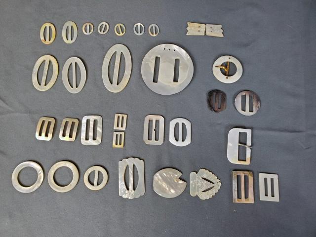 Group of 32 Mother of Pearl Buckles: Group of 32 mother of pearl buckles in various shapes measuring from .75 to almost 3 inches. Several pairs, one small duet. In good to very good condition. We do our best to describe all items in deta